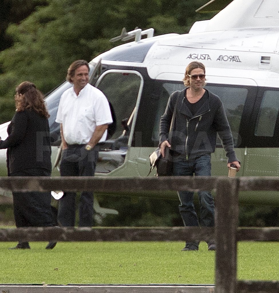 Brad Pitt carries a cup of coffee getting off the helicopter. Brad Pitt carries a cup of coffee getting off the helicopter.