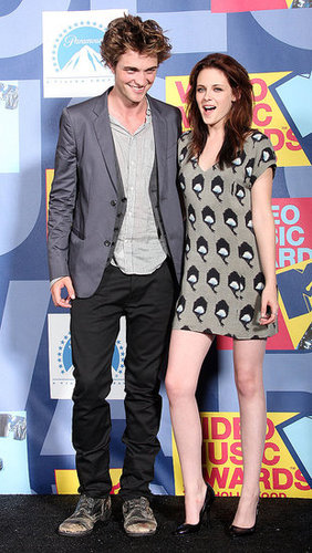 Kristen Stewart posed on the red carpet with Robert Pattinson in LA while wearing a hot minidress at the September 2008 MTV VMAs.
Kristen Stewart posed on the red carpet with Robert Pattinson in LA while wearing a hot minidress at the September 2008 MTV VMAs.