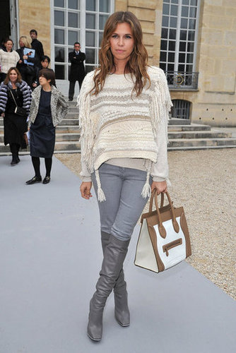 Dasha Zhukova paired gray knee-high boots with matching jeans, a cozy fringed sweater, and Celine bag at the Christian Dior show.
Dasha Zhukova paired gray knee-high boots with matching jeans, a cozy fringed sweater, and Celine bag at the Christian Dior show.