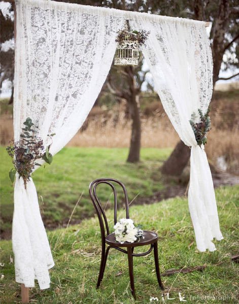 Dainty lace curtains, natural arrangements, and a delicate white birdcage create a rustic, elegant vibe.
Photo by Mile Photography via Style Me Pretty
Dainty lace curtains, natural arrangements, and a delicate white birdcage create a rustic, elegant vibe.
Photo by Mile Photography via Style Me Pretty
