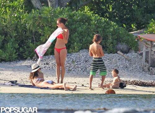 Miranda Kerr sprawled out in the sand with an eye on Flynn.
Miranda Kerr sprawled out in the sand with an eye on Flynn.