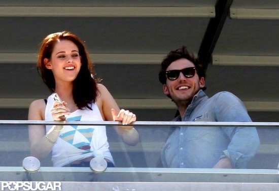 Kristen Stewart and Sam Claflin smiled big. Kristen Stewart and Sam Claflin smiled big.