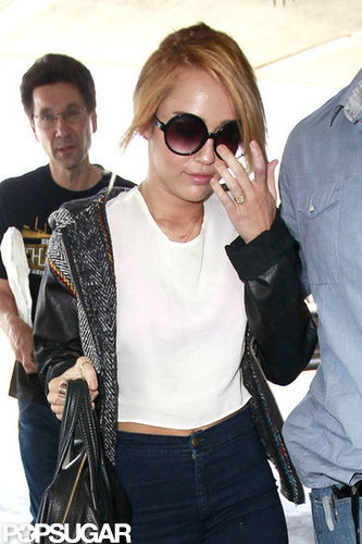 Miley Cyrus arrived at LAX showing off her engagement ring on her way to her flight.
Miley Cyrus arrived at LAX showing off her engagement ring on her way to her flight.