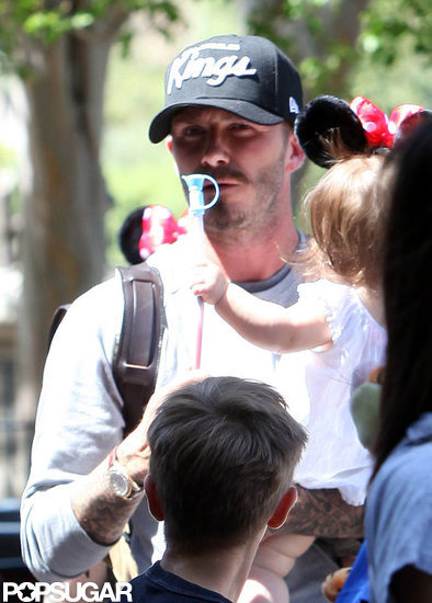 David Beckham carried baby Harper, wearing Minnie Mouse ears, during a trip to Disneyland.
David Beckham carried baby Harper, wearing Minnie Mouse ears, during a trip to Disneyland.