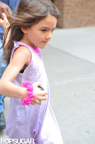 Suri Cruise wore a bright pink scrunchie on her wrist.
Suri Cruise wore a bright pink scrunchie on her wrist.