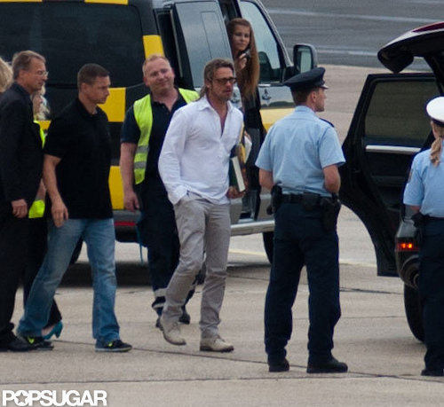 Brad Pitt walked through the airport tarmac.
Brad Pitt walked through the airport tarmac.