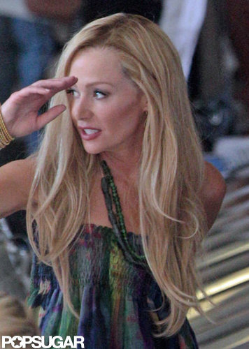 Portia de Rossi adjusted her long locks.
Portia de Rossi adjusted her long locks.
