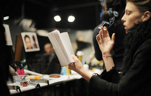 A model read while smoking a cigarette backstage during Milan Fashion Week in 2008.
A model read while smoking a cigarette backstage during Milan Fashion Week in 2008.