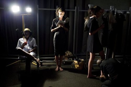 A model found a spot of light to read her book backstage during Fashion Week in South Africa.
A model found a spot of light to read her book backstage during Fashion Week in South Africa.