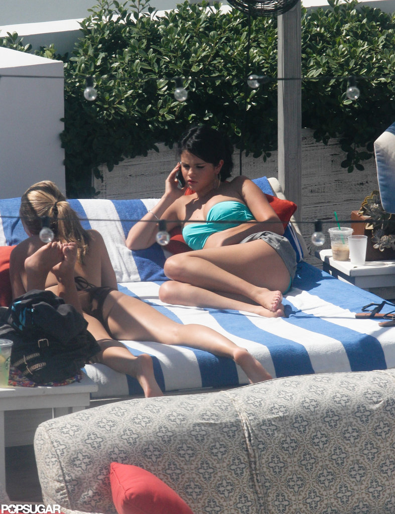 Selena Gomez lounged by the pool in Miami. Selena Gomez lounged by the pool in Miami.