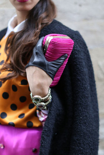 A pop of fuchsia on her clutch that looked like it could have been cut from the same fabric as her skirt.
A pop of fuchsia on her clutch that looked like it could have been cut from the same fabric as her skirt.