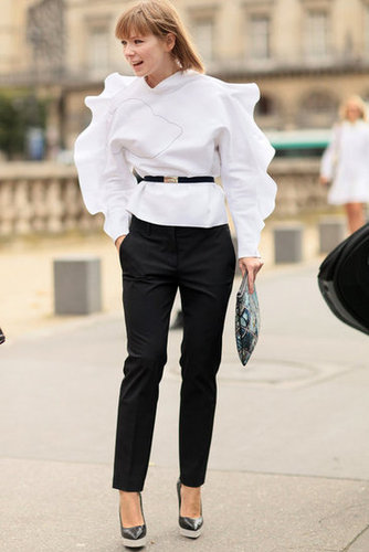 A ruffled blouse emboldens basic black trousers.
A ruffled blouse emboldens basic black trousers.