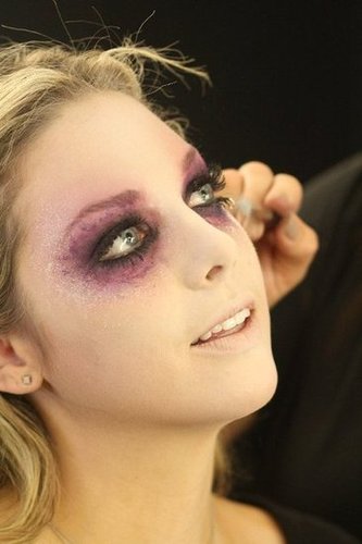 Using a blush brush, blend white powder around the edges of the face and down the neck. Tap a bit of MAC Pigment in Pro White around the eyes. Finally, dab some concealer on lips, then brush on an opalescent pigment (Zizzo used MAC's Pink Opal).
Using a blush brush, blend white powder around the edges of the face and down the neck. Tap a bit of MAC Pigment in Pro White around the eyes. Finally, dab some concealer on lips, then brush on an opalescent pigment (Zizzo used MAC's Pink Opal).