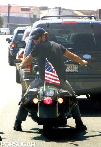 George Clooney waved his American pride on the back of his motorcycle while riding around LA in September 2001.
George Clooney waved his American pride on the back of his motorcycle while riding around LA in September 2001.