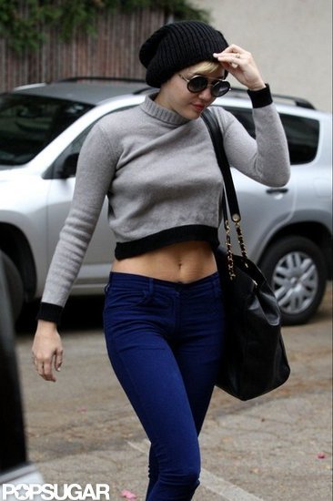 Miley Cyrus showed off her flat stomach in a gray crop top.
Miley Cyrus showed off her flat stomach in a gray crop top.