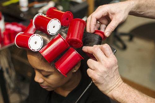 Roll one-inch sections around the sponge rollers, ensuring the hair is curled under. Let sit for 20 minutes to an hour before removing. The longer the better, but Dickey warned against sleeping in the rollers, which can lead to breakage. You can also sit under a cool hood dryer while you wait to enhance shine.
Roll one-inch sections around the sponge rollers, ensuring the hair is curled under. Let sit for 20 minutes to an hour before removing. The longer the better, but Dickey warned against sleeping in the rollers, which can lead to breakage. You can also sit under a cool hood dryer while you wait to enhance shine.