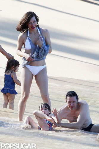 Bikini-Clad Milla Jovovich Poses Beachside With Her Family on NYE Bikini-Clad Milla Jovovich Poses Beachside With Her Family on NYE