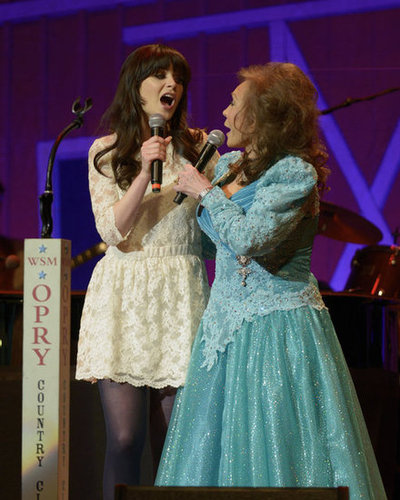 Zooey joined country legend Loretta Lynn on stage in a flared (and flirty) white lace number and dark tights.
Zooey joined country legend Loretta Lynn on stage in a flared (and flirty) white lace number and dark tights.