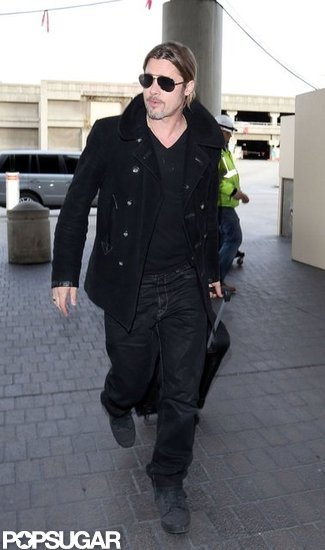 Brad Pitt wore his sunglasses as he arrived at LAX. Brad Pitt wore his sunglasses as he arrived at LAX.