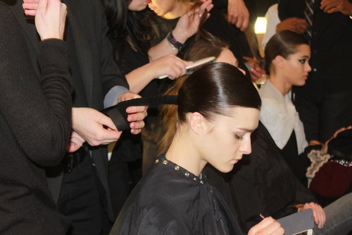 Odile Gilbert for Kérastase first blow-dried hair straight and slicked it back into a ponytail with a deep side part using the brand's Double Force hair spray for sleekness. Then the low pony was wrapped with suede ribbon and secured with elastic. Finally, the taut piece was twisted into a chignon.
Odile Gilbert for Kérastase first blow-dried hair straight and slicked it back into a ponytail with a deep side part using the brand's Double Force hair spray for sleekness. Then the low pony was wrapped with suede ribbon and secured with elastic. Finally, the taut piece was twisted into a chignon.