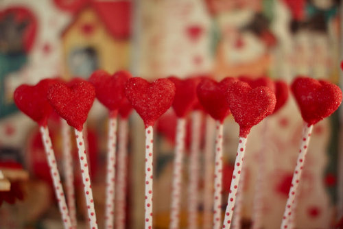 Candy-heart pops with a red polka-dot stem served as both decor and a sweet treat.
Source: Jenny Cookies
Candy-heart pops with a red polka-dot stem served as both decor and a sweet treat.
Source: Jenny Cookies