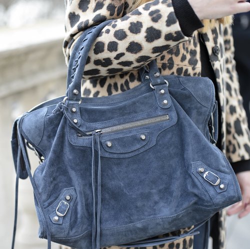 A blue suede Balenciaga bag popped against a leopard coat.
A blue suede Balenciaga bag popped against a leopard coat.