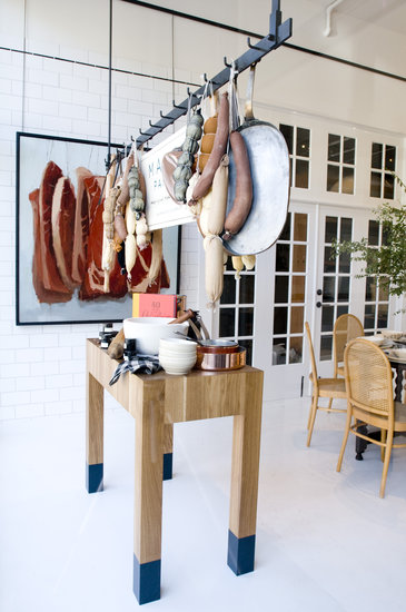 Utilize racks to hang more than just pots and pans. While you may not have ropes of sausage and dried salamis at the ready, things like potted herbs and sacks of garlic would achieve the same rustic culinary feel.
Utilize racks to hang more than just pots and pans. While you may not have ropes of sausage and dried salamis at the ready, things like potted herbs and sacks of garlic would achieve the same rustic culinary feel.