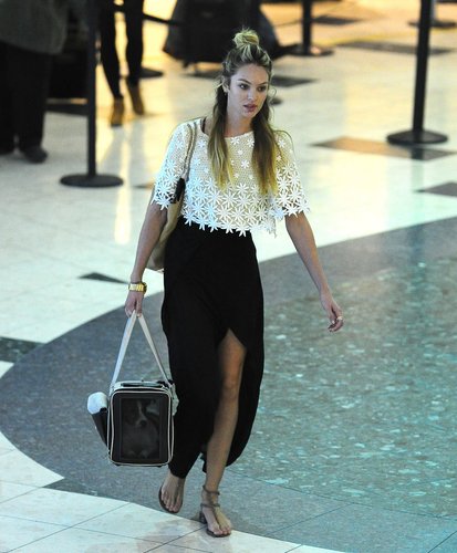 Candice Swanepoel traveled in style in a cropped lace top and black maxi skirt with a sexy slit.
Candice Swanepoel traveled in style in a cropped lace top and black maxi skirt with a sexy slit.