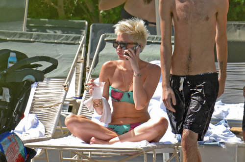 Miley Cyrus wore a bikini to relax poolside at the Ace Hotel in Palm Springs, CA.
Miley Cyrus wore a bikini to relax poolside at the Ace Hotel in Palm Springs, CA.