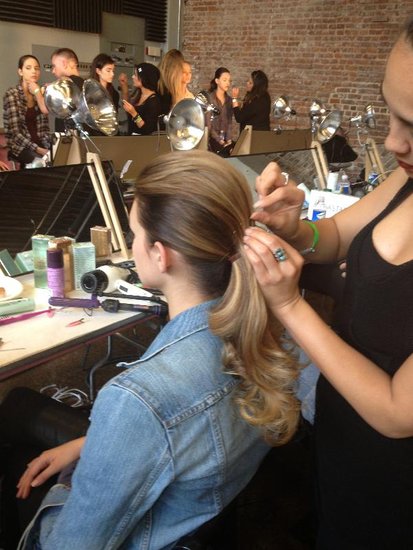 The next step: divide the hair into two sections — a smaller portion between the temples and a larger bottom part. The bottom section was secured into a low ponytail. Then the top piece was combed over the and held with bobby pins. A bride could transition back to this double ponytail look easily before the wedding reception.
The next step: divide the hair into two sections — a smaller portion between the temples and a larger bottom part. The bottom section was secured into a low ponytail. Then the top piece was combed over the and held with bobby pins. A bride could transition back to this double ponytail look easily before the wedding reception.