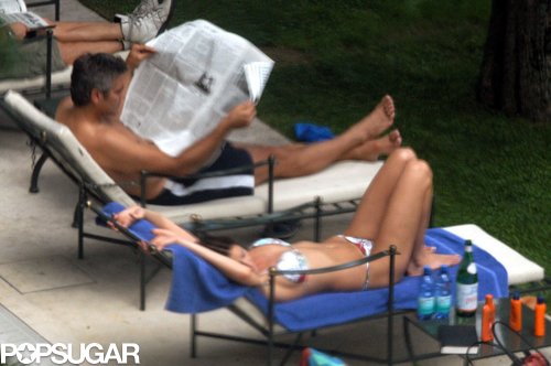 George Clooney read a newspaper in June 2004 while soaking up the Lake Como sun with former girlfriend Lisa Snowdon.
George Clooney read a newspaper in June 2004 while soaking up the Lake Como sun with former girlfriend Lisa Snowdon.