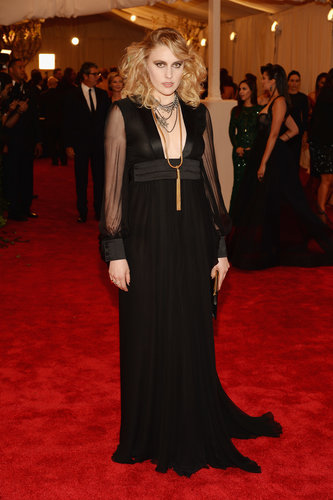 Greta Gerwig's black Saint Laurent gown featured a sexy plunging neckline and sheer sleeves. She finished with Fred Leighton gold jewels and Christian Louboutin Pigalle pumps.
Greta Gerwig's black Saint Laurent gown featured a sexy plunging neckline and sheer sleeves. She finished with Fred Leighton gold jewels and Christian Louboutin Pigalle pumps.