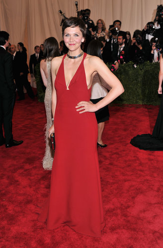 Maggie Gyllenhaal revealed some front and side cleavage in a red halter gown by Calvin Klein Collection. She accessorized with a Tod's clutch and Bulgari jewels.
Maggie Gyllenhaal revealed some front and side cleavage in a red halter gown by Calvin Klein Collection. She accessorized with a Tod's clutch and Bulgari jewels.
