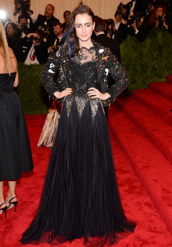 Lily Collins roughed up her red carpet style in a black-and-gold Moschino gown, topped with a studded blazer.
Lily Collins roughed up her red carpet style in a black-and-gold Moschino gown, topped with a studded blazer.