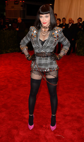 There was no such thing as too much punk for Madonna. The icon picked a Givenchy Haute Couture by Riccardo Tisci look that combined tartan, shredded fishnets, black leather, chains, and plenty of studs. Casadei ankle-strap pumps pulled in a pop of punky pink.
There was no such thing as too much punk for Madonna. The icon picked a Givenchy Haute Couture by Riccardo Tisci look that combined tartan, shredded fishnets, black leather, chains, and plenty of studs. Casadei ankle-strap pumps pulled in a pop of punky pink.