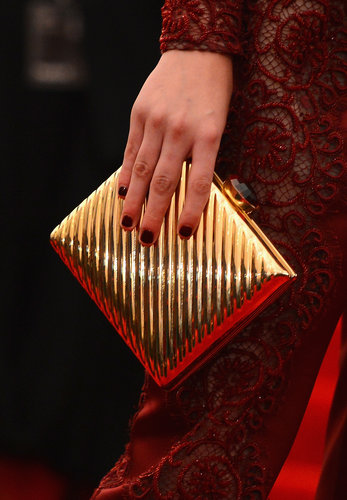 Kristen Stewart carried a gold box clutch alongside her Stella McCartney look.
Kristen Stewart carried a gold box clutch alongside her Stella McCartney look.