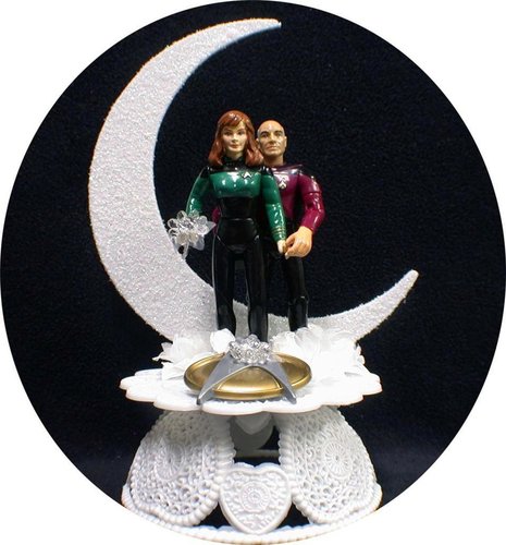 Captain Picard and Dr. Beverly Crusher show their love is out of this world with this white moon-shaped wedding cake topper ($66).
Captain Picard and Dr. Beverly Crusher show their love is out of this world with this white moon-shaped wedding cake topper ($66).