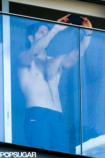 Bradley Cooper snapped photos on his cell phone while spending time shirtless on his hotel balcony.
Bradley Cooper snapped photos on his cell phone while spending time shirtless on his hotel balcony.