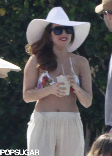 Lady Gaga drank a cold beverage poolside.
Lady Gaga drank a cold beverage poolside.