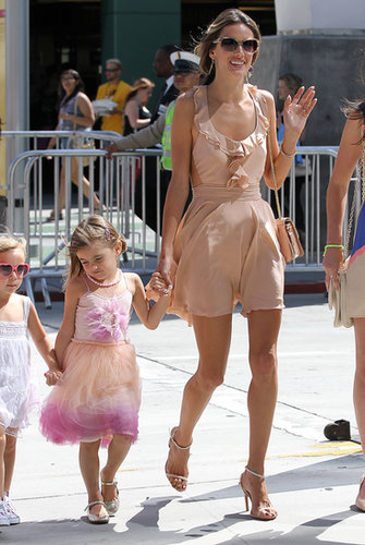 Alessandra waved in a peachy ruffled minidress and matching ankle-strap sandals in LA.
Alessandra waved in a peachy ruffled minidress and matching ankle-strap sandals in LA.
