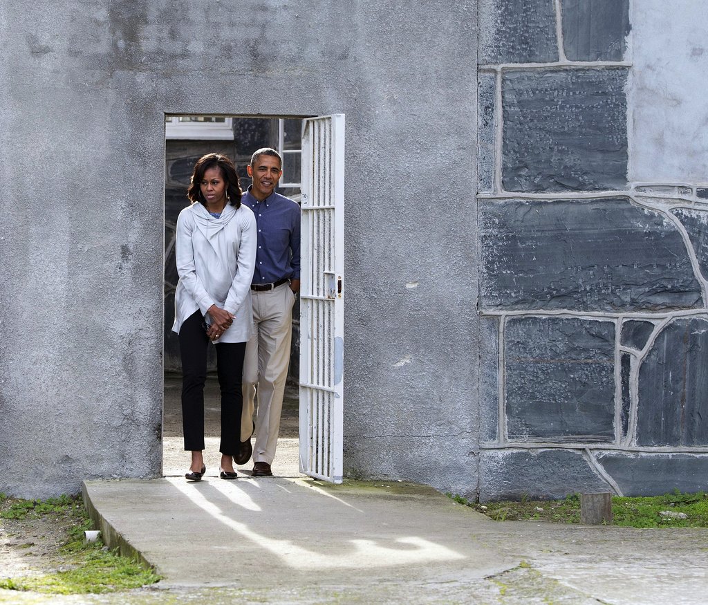 For her visit to Robben Island in South Africa, Michelle kept her look much more subdued in black cropped trousers and a gray cowl-neck jacket.
For her visit to Robben Island in South Africa, Michelle kept her look much more subdued in black cropped trousers and a gray cowl-neck jacket.
