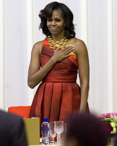 Michelle Obama was fabulous as ever in a sunset-print, one-shoulder Naeem Khan dress and Robert Lee Morris gold necklace during a dinner in South Africa.
Michelle Obama was fabulous as ever in a sunset-print, one-shoulder Naeem Khan dress and Robert Lee Morris gold necklace during a dinner in South Africa.