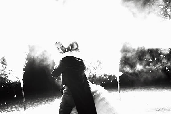 The newlyweds embraced amongst ground fireworks.
Photo by Nick Tucker via Snippet and Ink
The newlyweds embraced amongst ground fireworks.
Photo by Nick Tucker via Snippet and Ink