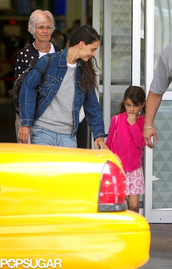 Katie Holmes held Suri Cruise's hand as they arrived at JFK Airport. Katie Holmes held Suri Cruise's hand as they arrived at JFK Airport.
