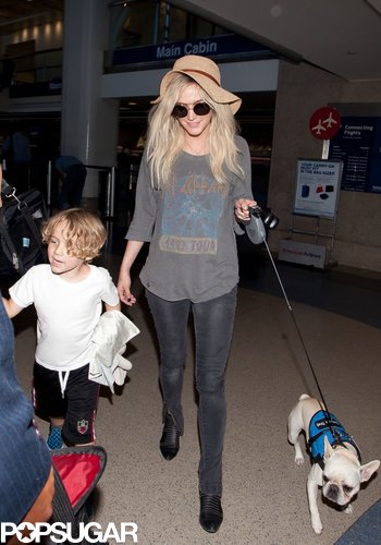If you can pry your eyes away from Ashlee Simpson's cute pup for just a minute, you'll notice her relaxed traveling look: faded band shirt, black skinnies, and floppy hat.
If you can pry your eyes away from Ashlee Simpson's cute pup for just a minute, you'll notice her relaxed traveling look: faded band shirt, black skinnies, and floppy hat.