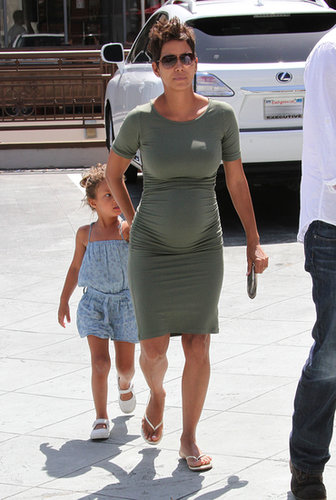 Halle put her adorable baby bump on display in a formfitting green t-shirt dress, then finished with gold flip-flops. If you, too, want to show off your figure, reach for a similar body-con silhouette.
Halle put her adorable baby bump on display in a formfitting green t-shirt dress, then finished with gold flip-flops. If you, too, want to show off your figure, reach for a similar body-con silhouette.