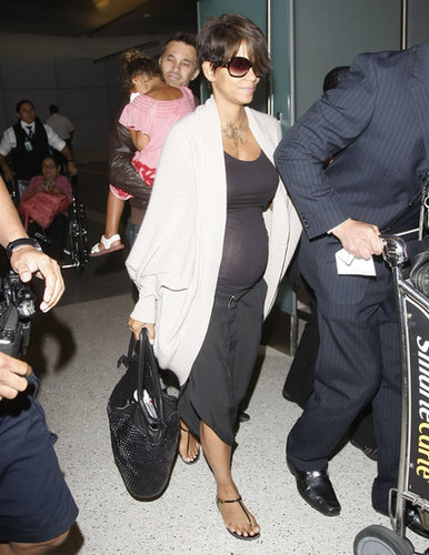 Halle Berry put her growing baby bump on display in a black tank and black cropped trousers, which she finished with black t-strap sandals and a Foley+Corinna tote when she arrived to LA from France following her nuptials to Olivier Martinez.
Halle Berry put her growing baby bump on display in a black tank and black cropped trousers, which she finished with black t-strap sandals and a Foley+Corinna tote when she arrived to LA from France following her nuptials to Olivier Martinez.
