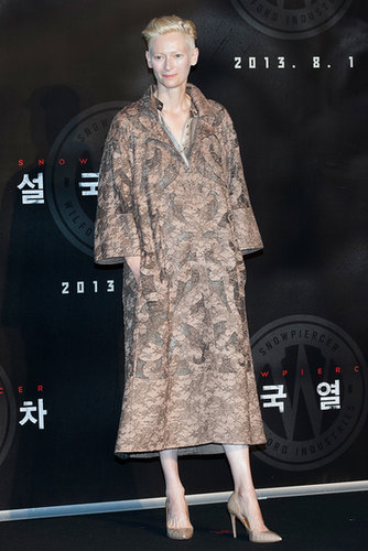 Tilda Swinton greeted fans at a Snowpiercer press conference in a lacy coat from the Valentino Haute Couture collection.
Tilda Swinton greeted fans at a Snowpiercer press conference in a lacy coat from the Valentino Haute Couture collection.