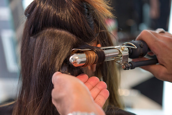 Once your hair has been smoothed out with the blow dryer, grab a large curling iron to form your waves. Start off by sectioning your hair at the nape of your neck and spray each section with a flexible hold hair spray like Kerastase Double Force ($39) for heat protection and hold. Then, wrap your hair around the iron, making sure to curl all the way to the end for an even curl.
Once your hair has been smoothed out with the blow dryer, grab a large curling iron to form your waves. Start off by sectioning your hair at the nape of your neck and spray each section with a flexible hold hair spray like Kerastase Double Force ($39) for heat protection and hold. Then, wrap your hair around the iron, making sure to curl all the way to the end for an even curl.