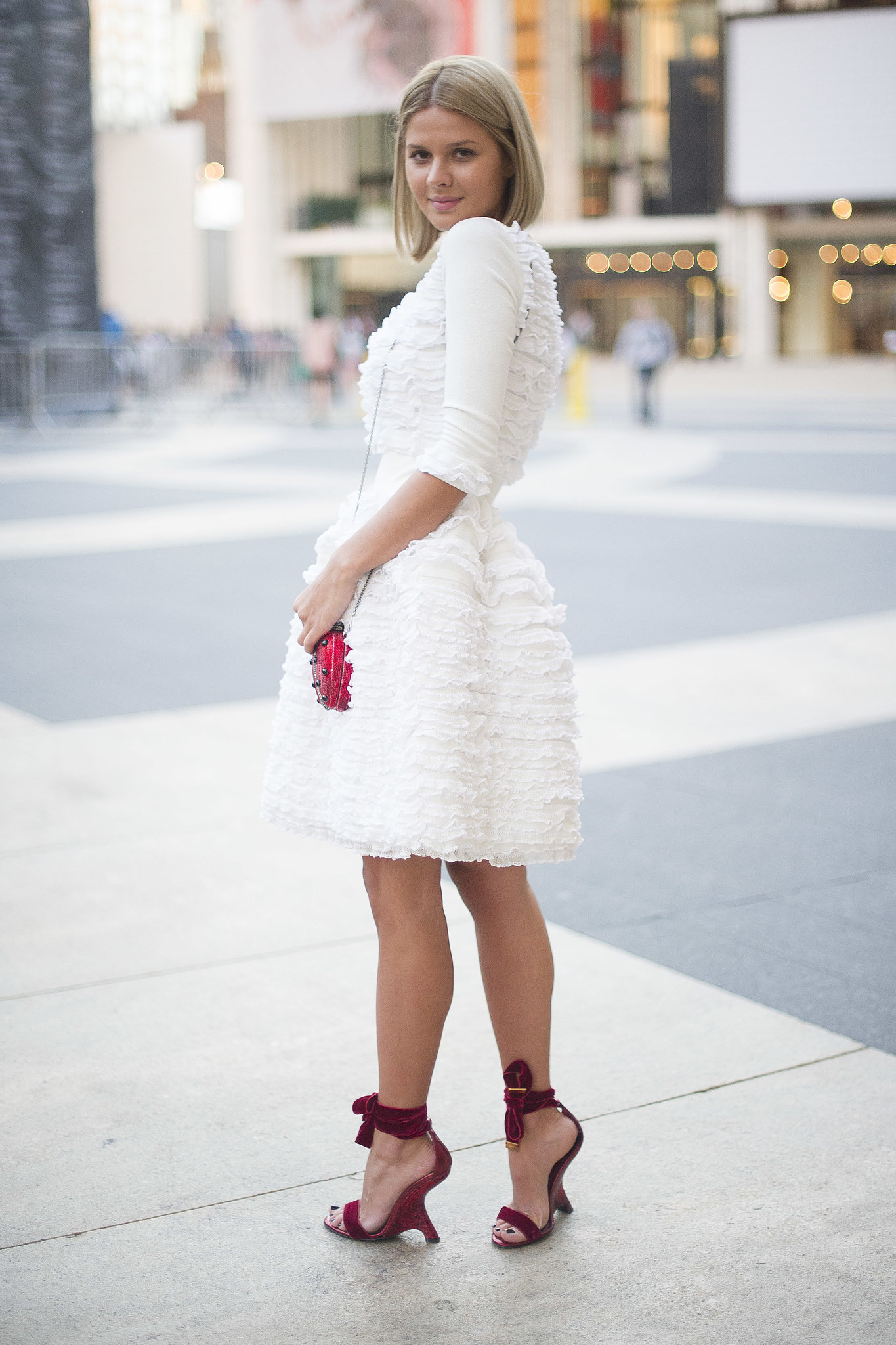 Only the best for Lincoln Center — this showgoer slipped into a frilly white dress and bow-tied heels. 
